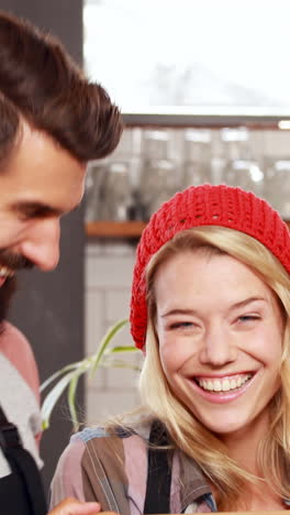 hipster couple holding open sign