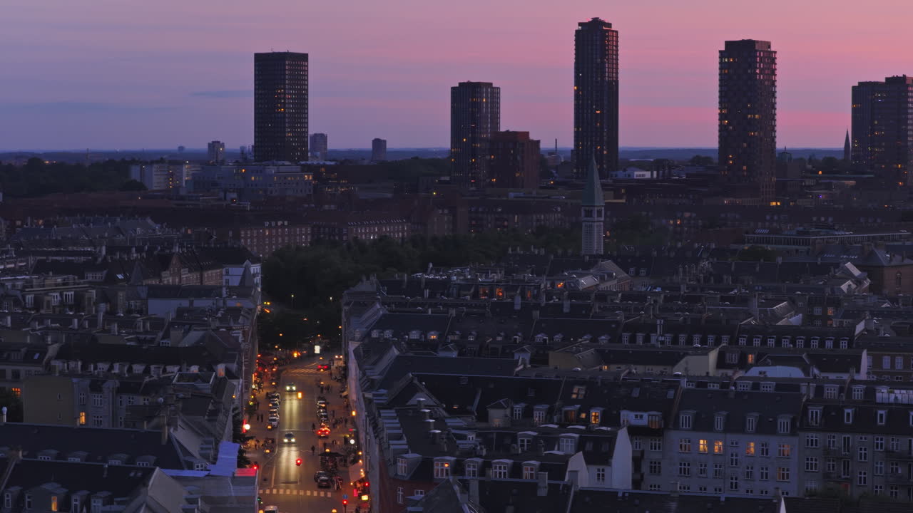 Aerial drone view of Copenhagen's skyline at twilight, featuring the Bispebjerg towers rising above the city