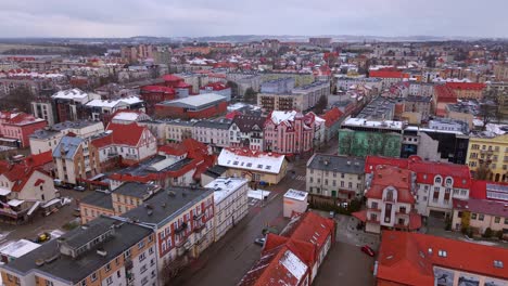 Snow over Elk city colorful buildings and neighbourhood in winter, Adama Mickiewicza street, Establishing drone shot
