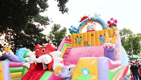 children playing on colorful inflatable slide