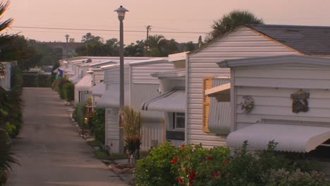 rows of homes near a walking path at a trailer park