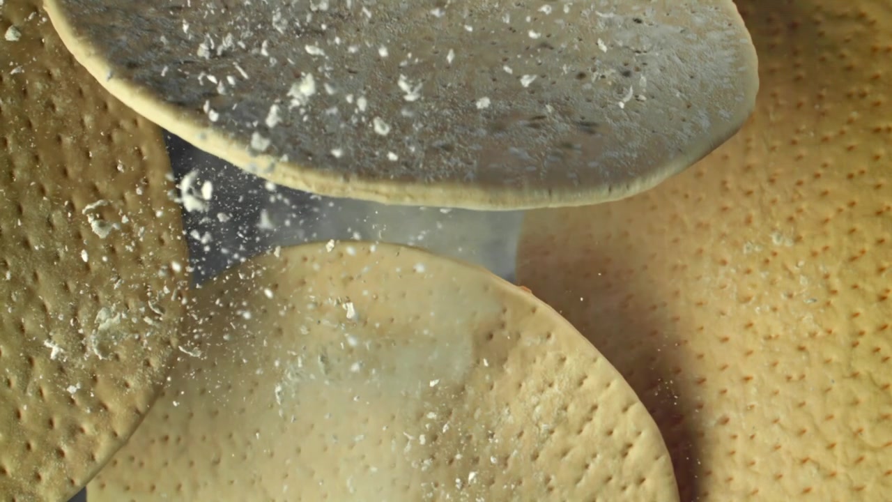 Slow Motion of Flour Falling on Pizza Dough Bases