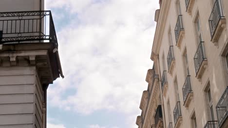 a passenger plane coming into land, passes by the gap between two old buildings in nantes, france