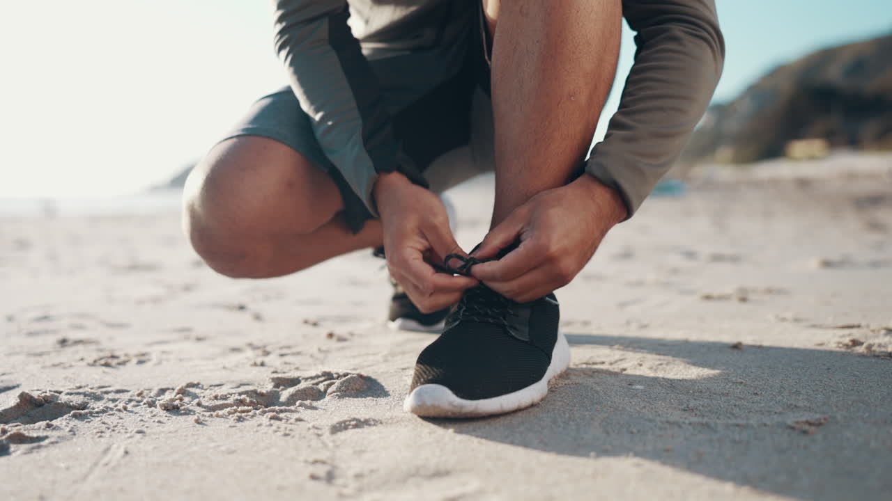 Feet, runner and tie shoes at beach for running