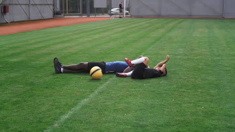 soccer players resting on field