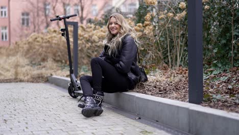 woman sitting near electric scooter