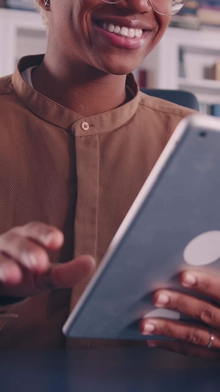 Successful african american woman with tablet computer sits in office at table