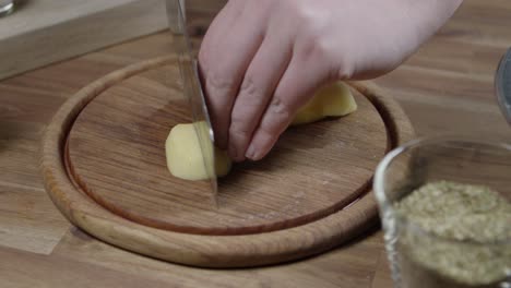 Chef-cuts-raw-potatoes-into-stripes