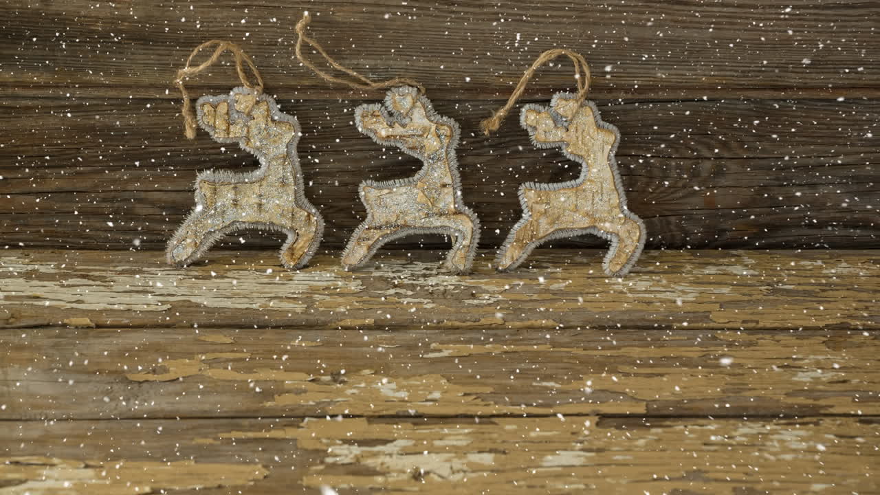 Falling snow with Christmas reindeer decoration on wood