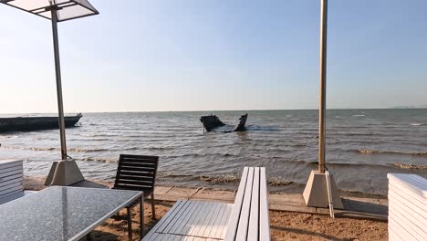 empty seaside restaurant with boats in view