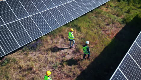Team-walking-at-solar-panel-farm-for-inspection