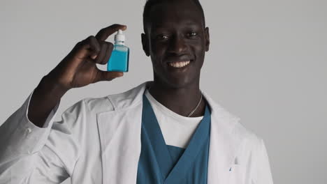 African american doctor on grey background.