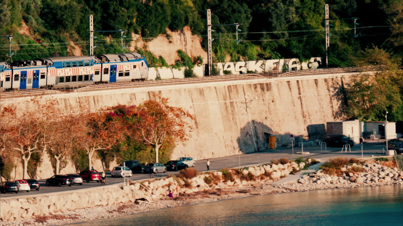 Train going moving near a beach in Villefranche sur Mer, France
