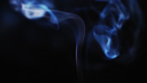 abstract blue color smoke with a black background in slow motion