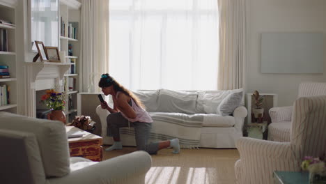 happy young woman singing at home having fun dancing enjoying karaoke music celebrating on weekend morning