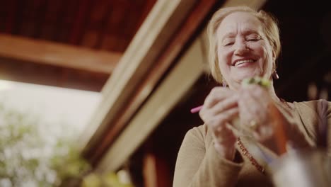 happy senior woman potting a small succulent plant