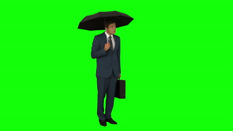 businessman standing under umbrella