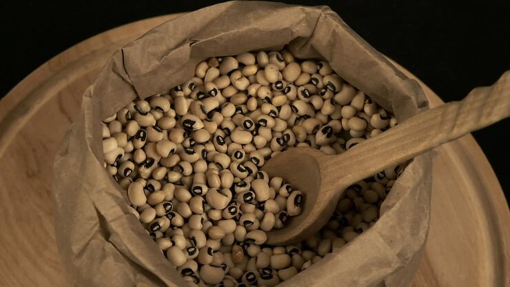High angle view: Nutritious dried black-eyed peas rotate in paper bag
