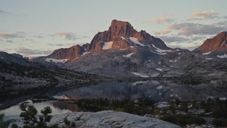 serene view of rugged mountains and calm lake at sunset along the john muir trail in summer