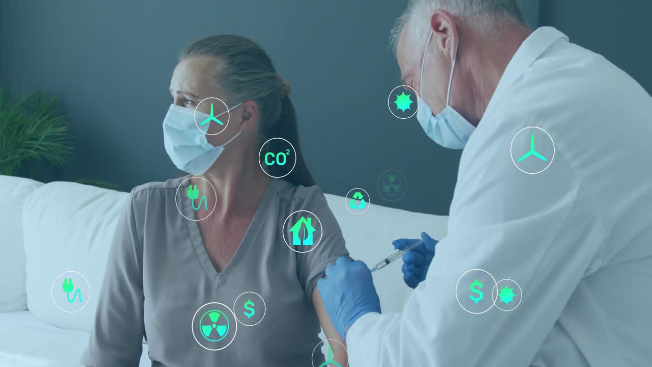 Mature woman extending arm on white sofa while doctor injecting vaccine and launching green icons