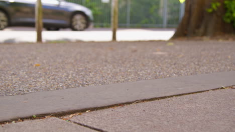 close up of woman wearing training shoes exercising running along pavement of city street 1