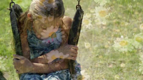 una niña triste sentada en un columpio