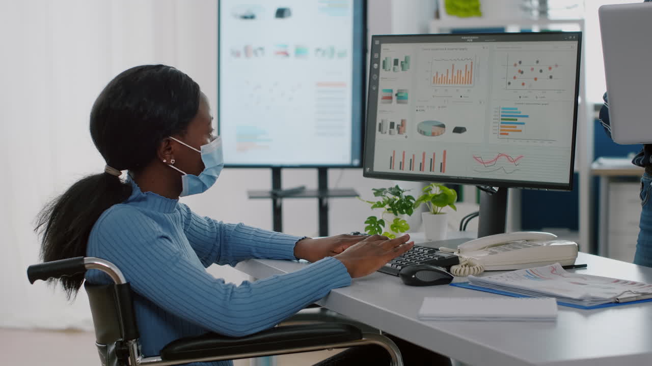 Invalid african employee with medical face mask discussing with coworker
