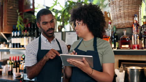 restaurant staff discussing order on tablet