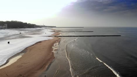 Aerial-shot-of-sandy-beach-in-Ustka-in-winter