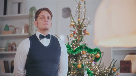 thoughtful man standing by decorated christmas tree at home