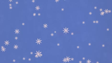 Animation-of-falling-snow-over-blue-background