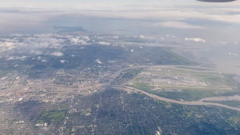 flying through clouds over coastal city