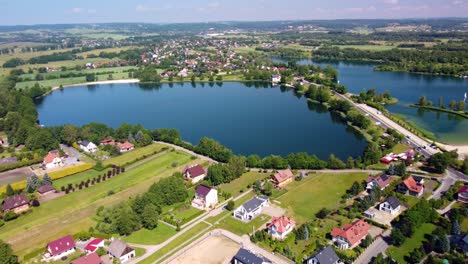 the water park and surrounding residential area are visible alongside the clear blue waters and lush greenery