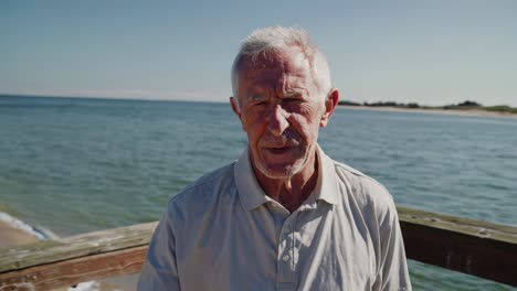 senior man holding pill package on a pier