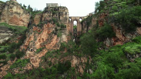 flyover hiker toward waterfall and puente nuevo bridge in ronda, andalusia, spain