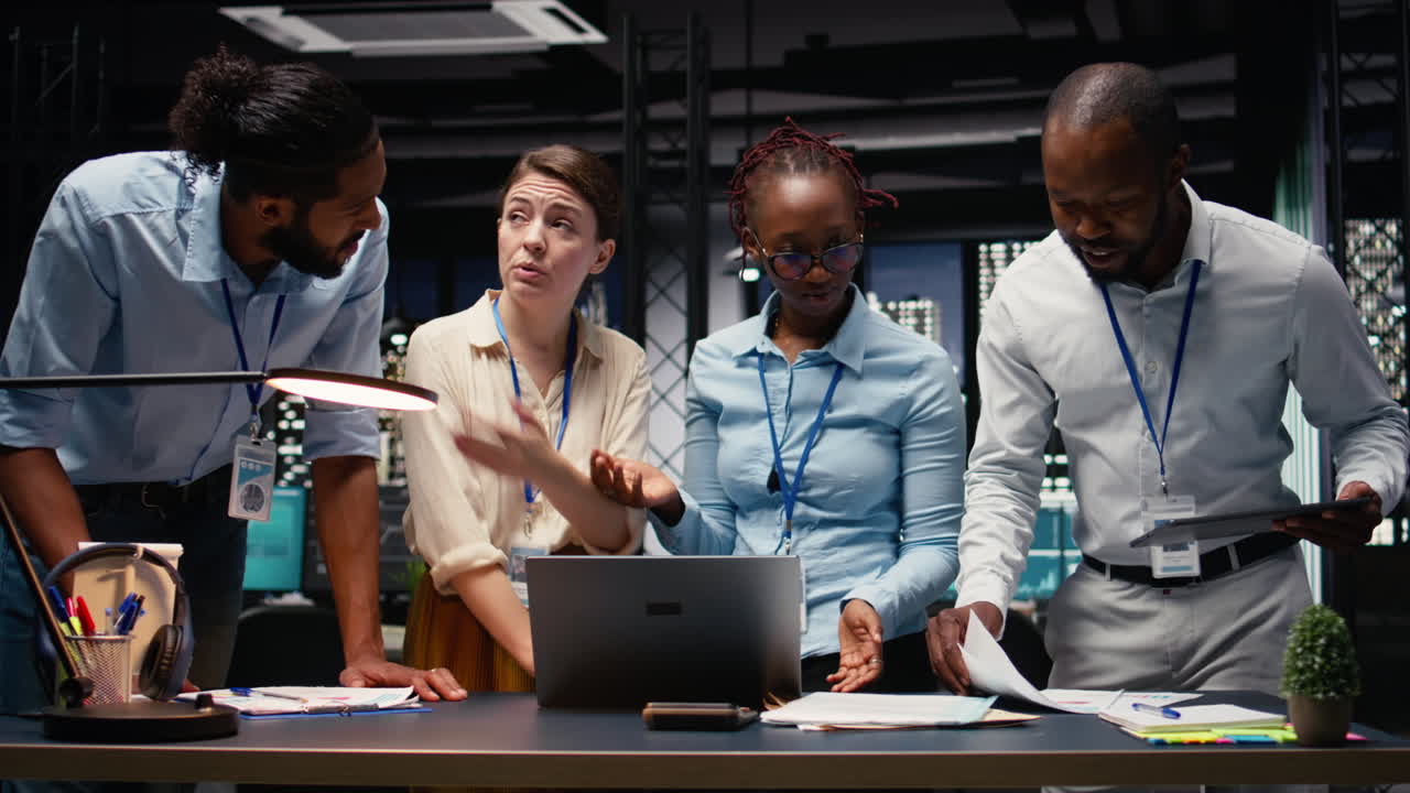 Group of professionals collaborating late on project management tasks
