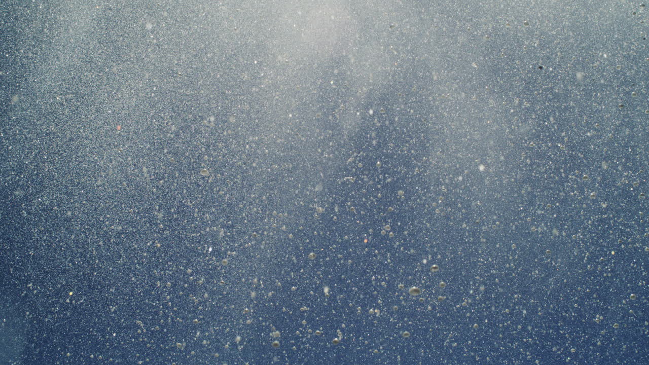 High-speed shot of water particles forming abstract misty shapes in ocean air burst