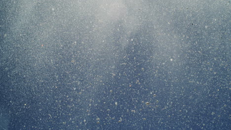 high-speed shot of water particles forming abstract misty shapes in ocean air burst