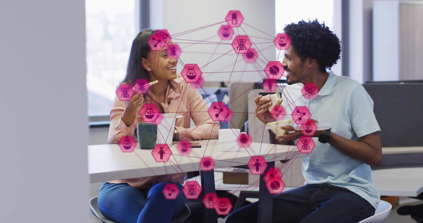 Colleagues unwrapping noodles drawing pulsing network nodes between them showing business teamwork