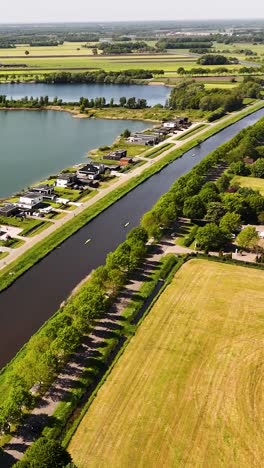 Aerial View of a Scenic Canal and Residential Area with Kayakers