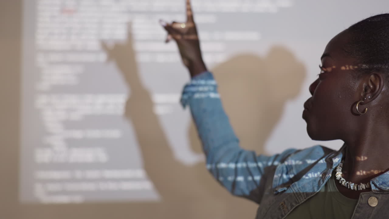 Woman giving a presentation with projected code