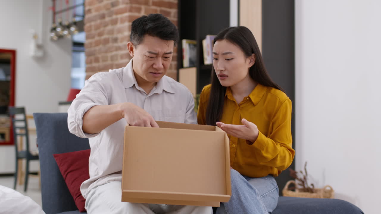 Couple arguing about a moving box