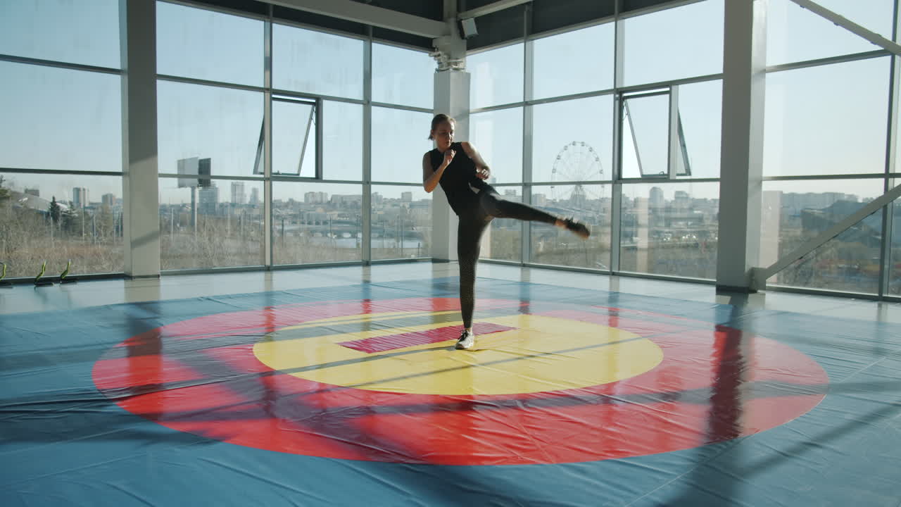 Woman practicing martial arts in a gym