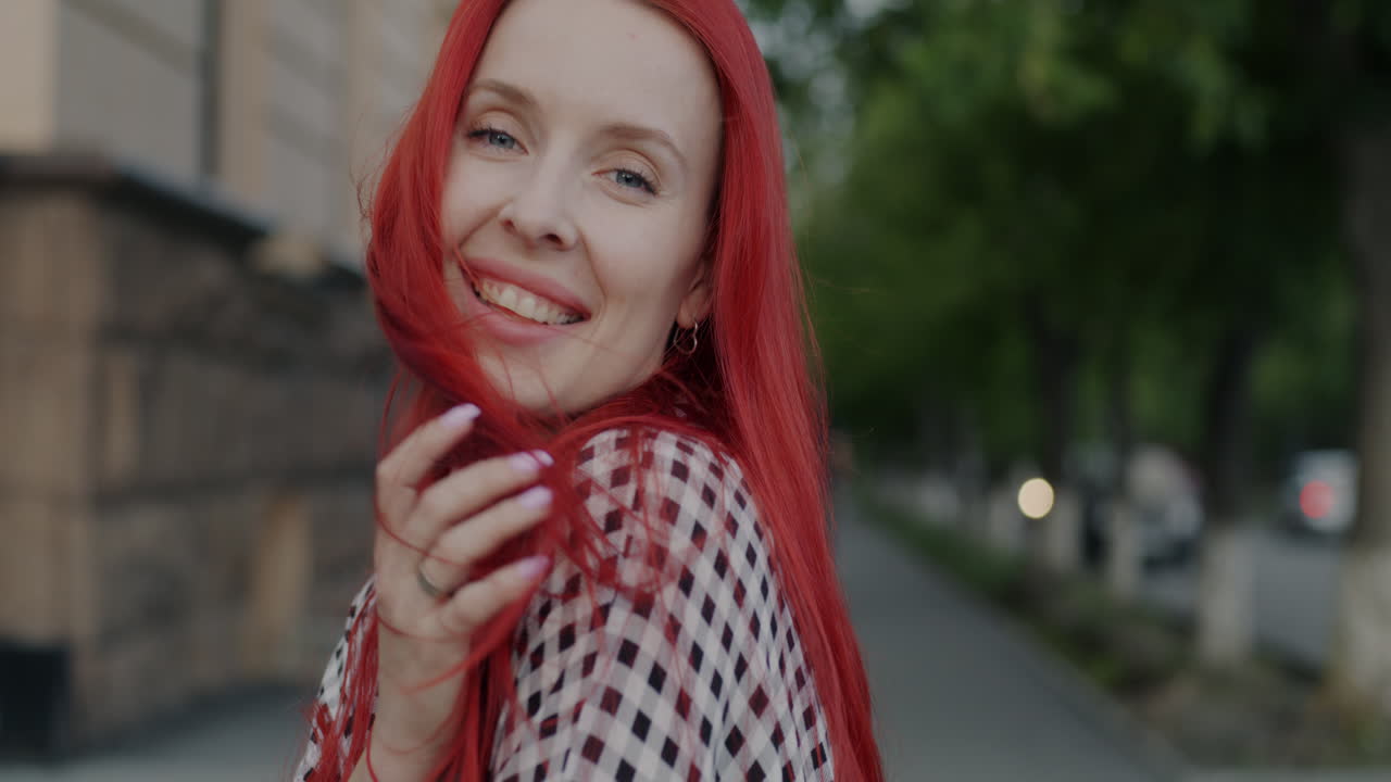Smiling woman with red hair outdoors