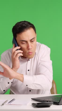 Office worker arguing on phone with green screen