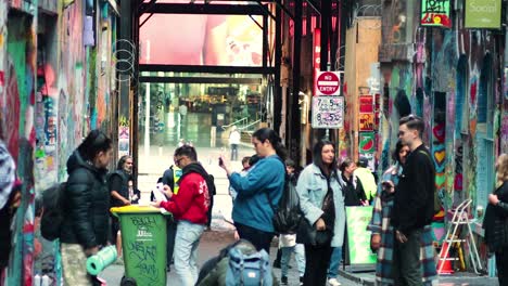 group painting graffiti on melbourne's iconic hosier lane