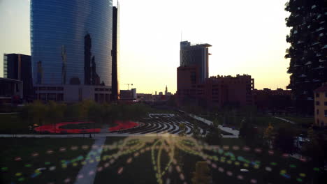cityscape with modern buildings and digital network animation overlaying green park