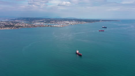 aerial view over large crude oil tankers commercial port at the mediterranean