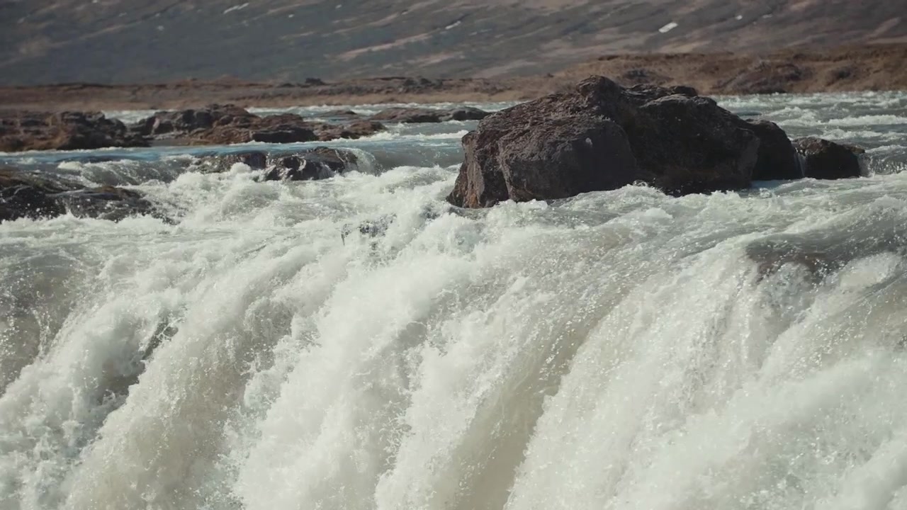 Powerful Rushing Water Over Rocks in a Natural River Landscape