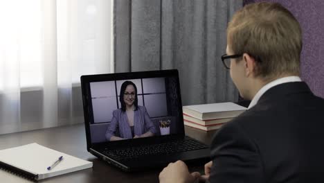 Businessman-make-video-chat-call-with-woman-on-laptop.-Distance-conference